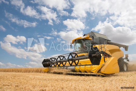 Picture of close view of modern combine harvester in action